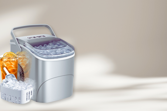 A silver countertop ice maker with a basket of ice and one iced drink in front.