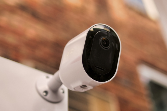 Black and white outdoor security cameras with sleek, modern designs.