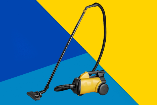 A canister vacuum cleaner with a sleek black and blue design, placed against a vibrant yellow background with geometric patterns