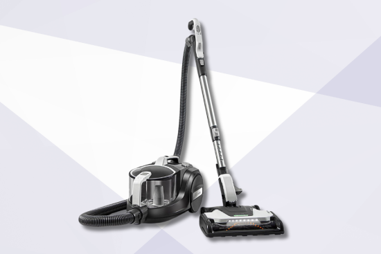 A sleek canister vacuum cleaner with a flexible hose and motorized floor head, displayed against a modern geometric background in shades of white and light gray.