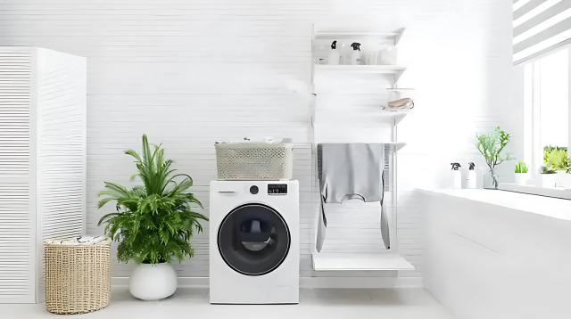 Minimalist laundry room with a compact washing machine, a drying rack, and plants, featuring bright natural light and white decor