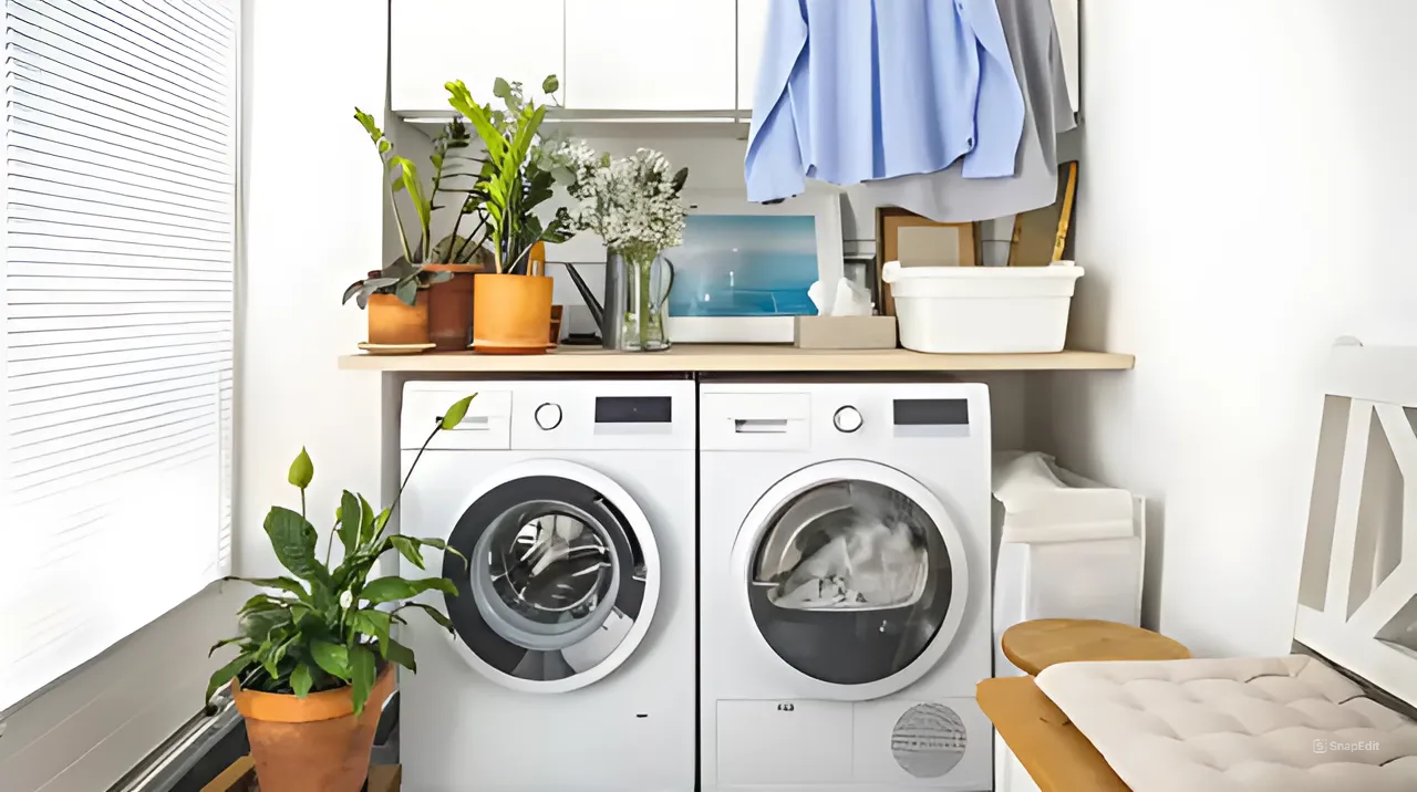 Modern laundry room with portable  washer and dryer, plants, and decor on top of a wooden shelf, with folded laundry and hanging clothes nearby