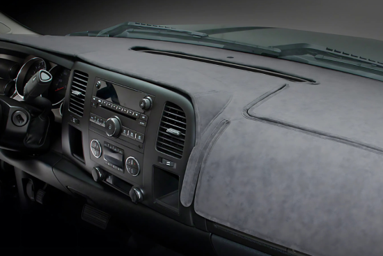 This image displays a car dashboard fitted with a custom suede-like dash cover, providing protection against sun damage and reducing glare.