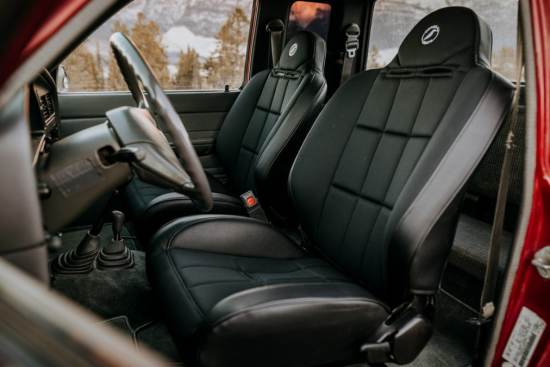 A car interior featuring sleek black seat covers designed for durability and comfort. The covers provide a snug fit, complementing the vehicle's interior aesthetics while protecting the original upholstery.