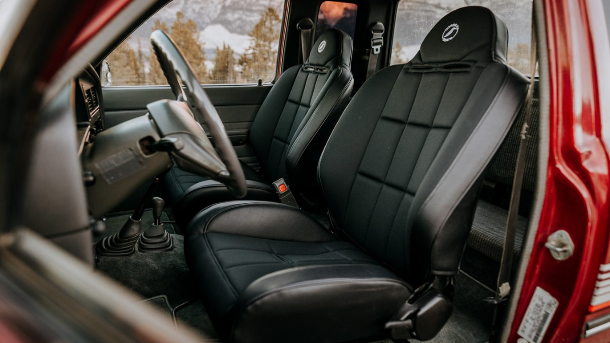 A car interior featuring sleek black seat covers designed for durability and comfort. The covers provide a snug fit, complementing the vehicle's interior aesthetics while protecting the original upholstery.