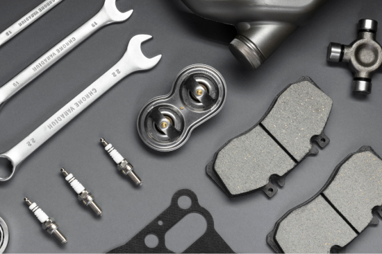 This image showcases an assortment of automotive tools and parts, including wrenches, spark plugs, brake pads, gaskets, and other essential components.