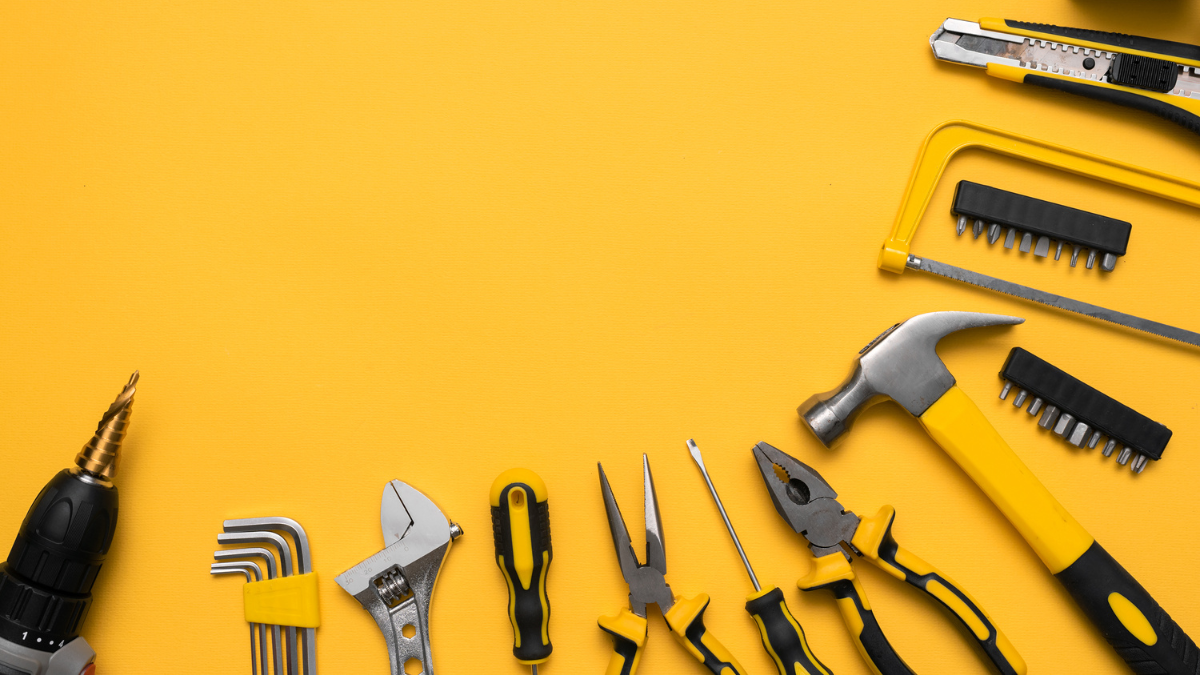 This image displays a vibrant arrangement of hand tools against a bright yellow background.