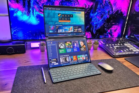 A dual-screen laptop setup on a stylish wooden desk, surrounded by gaming and multimedia accessories, with vibrant purple and blue neon lighting in the background.