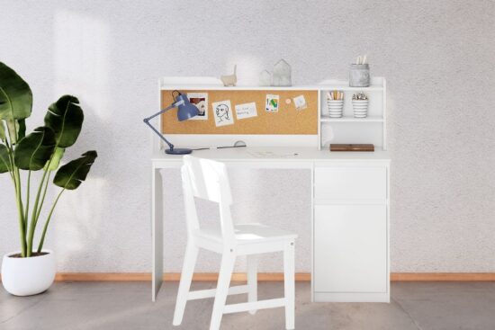 A white UTEX Kids Study Desk with Chair featuring a corkboard, storage shelves, and a simple design, placed in a bright room with a potted plant and clean decor.