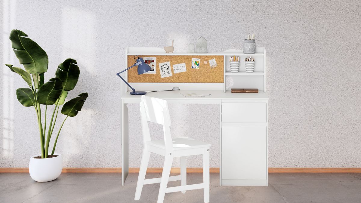 A white UTEX Kids Study Desk with Chair featuring a corkboard, storage shelves, and a simple design, placed in a bright room with a potted plant and clean decor.