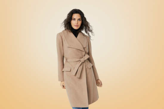 A woman wearing a sophisticated camel-colored wrap coat with a belted waist and wide lapels, ideal for an elegant winter look.