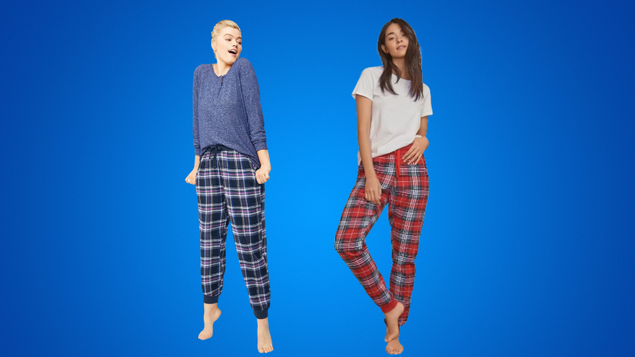 Two women wearing plaid pajama pants, one with a blue sweater and the other with a white T-shirt.