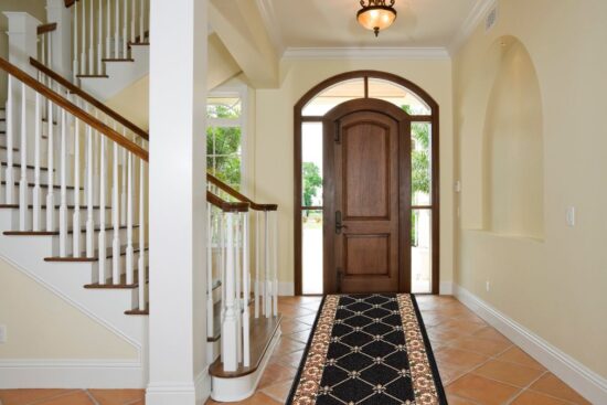 CreativeDeco Custom Runner Rug in a black and gold design placed in an entryway.