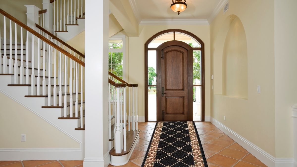 CreativeDeco Custom Runner Rug in a black and gold design placed in an entryway.