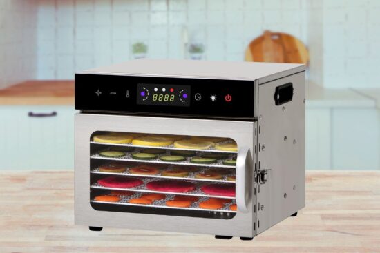 A stainless steel food dehydrator with multiple trays, showing colorful fruits drying inside.