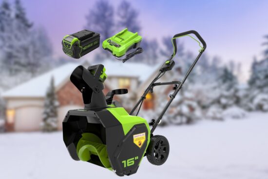 A Greenworks 40V 16-Inch Cordless Snow Blower is displayed with its battery and charger, set against a snowy background featuring a cozy home and snow-covered trees.