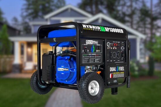 A portable generator with a black frame and blue engine, shown in front of a house.