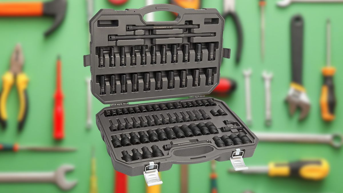 A black impact socket set in an open hard case with various socket sizes, placed in front of a green background with hand tools.