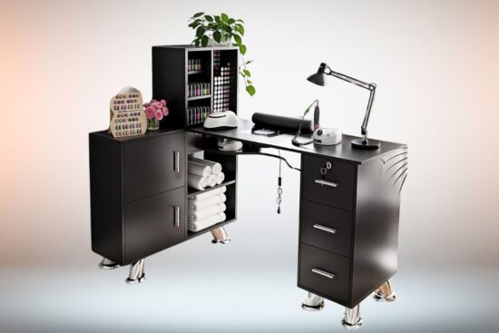 A black L-shaped manicure table with storage cabinets, drawers, and a built-in nail station setup, featuring nail polish displays, towels, and salon tools.