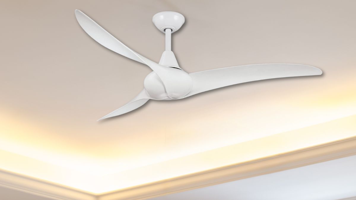 A sleek white ceiling fan with three curved blades is mounted on a modern ceiling with soft ambient lighting.