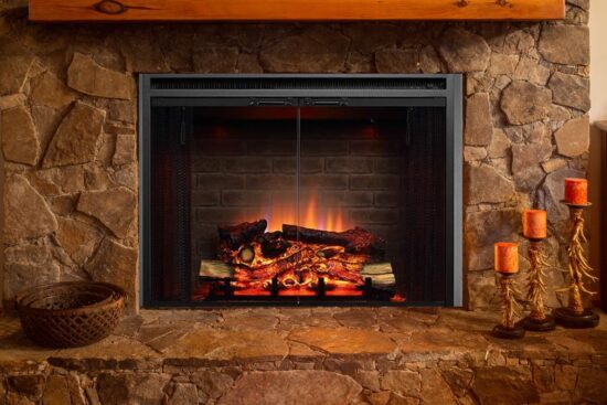 A cozy electric fireplace with glowing logs and flickering flames inside a stone fireplace setting.