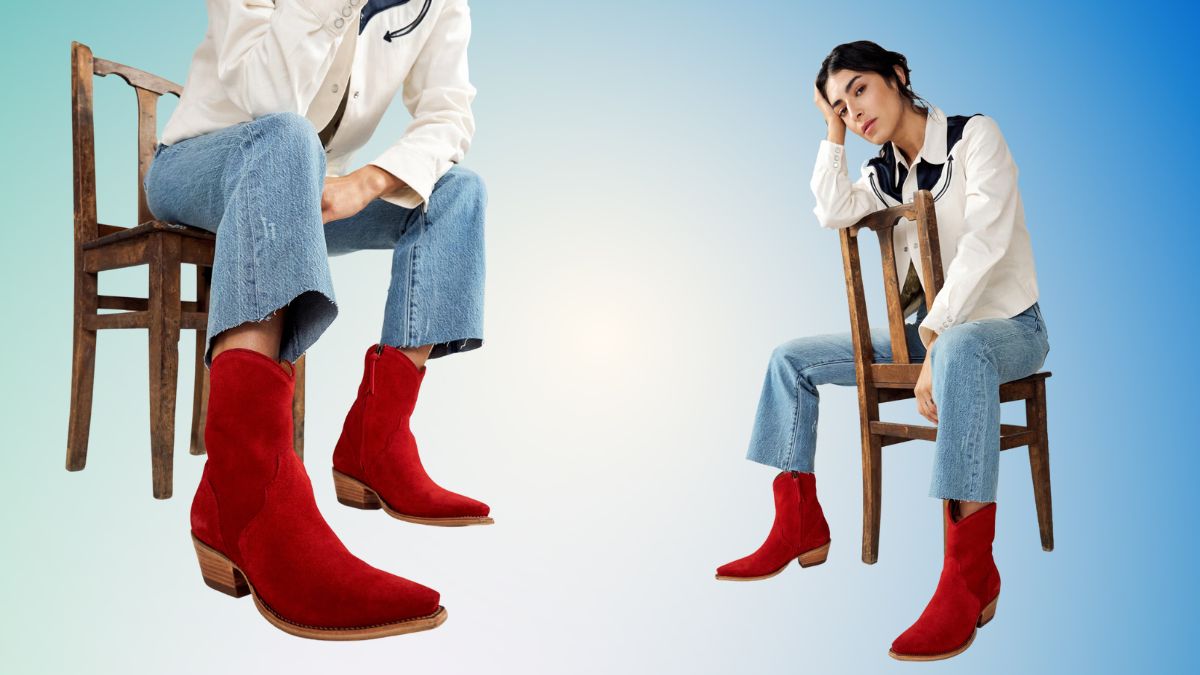 A woman wearing red western boots, blue jeans, and a white shirt sits on a wooden chair against a light blue background.