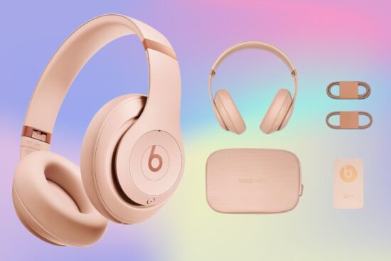 Beats wireless headphones in a soft pink color with a matching case, cables, and accessories on a pastel background.