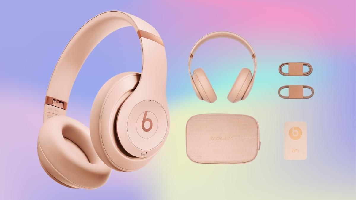 Beats wireless headphones in a soft pink color with a matching case, cables, and accessories on a pastel background.
