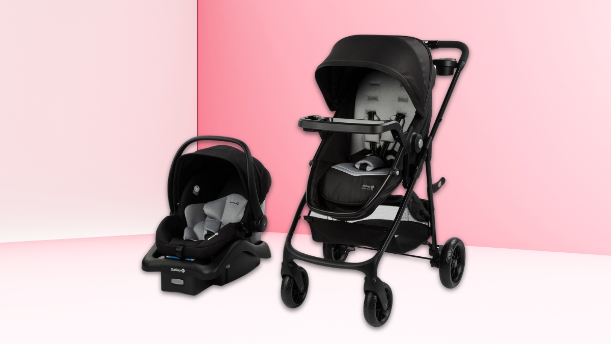 A black Safety 1st Grow and Go Flex 8-in-1 Travel System with a stroller and infant car seat set against a pink and white background.