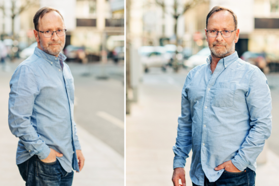 Older man wearing a light blue casual shirt outdoors.