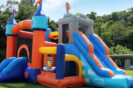 Colorful Inflantteble 16FT commercial kids bounce house with dual slides, climbing wall, and mesh sides set up on grass.