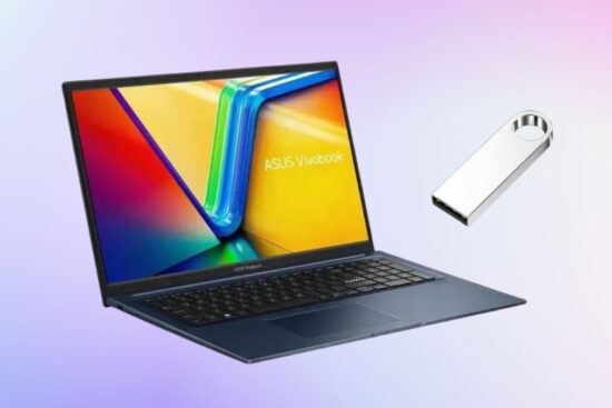 Blue ASUS Vivobook 17-inch laptop with a colorful screen and a silver USB drive floating beside it on a soft gradient background.