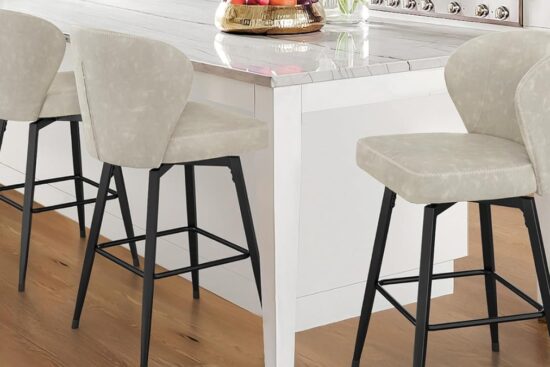 Three LUE BONA 26-inch swivel bar stools with faux leather seats and black metal legs are placed around a white kitchen island.