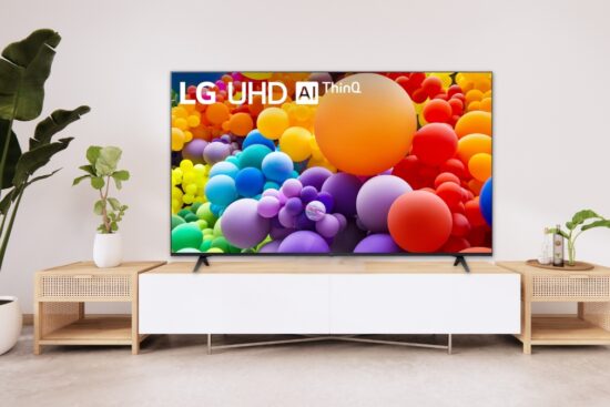 A large LG UHD AI ThinQ TV on a modern TV stand, displaying a colorful screen with floating bubbles.