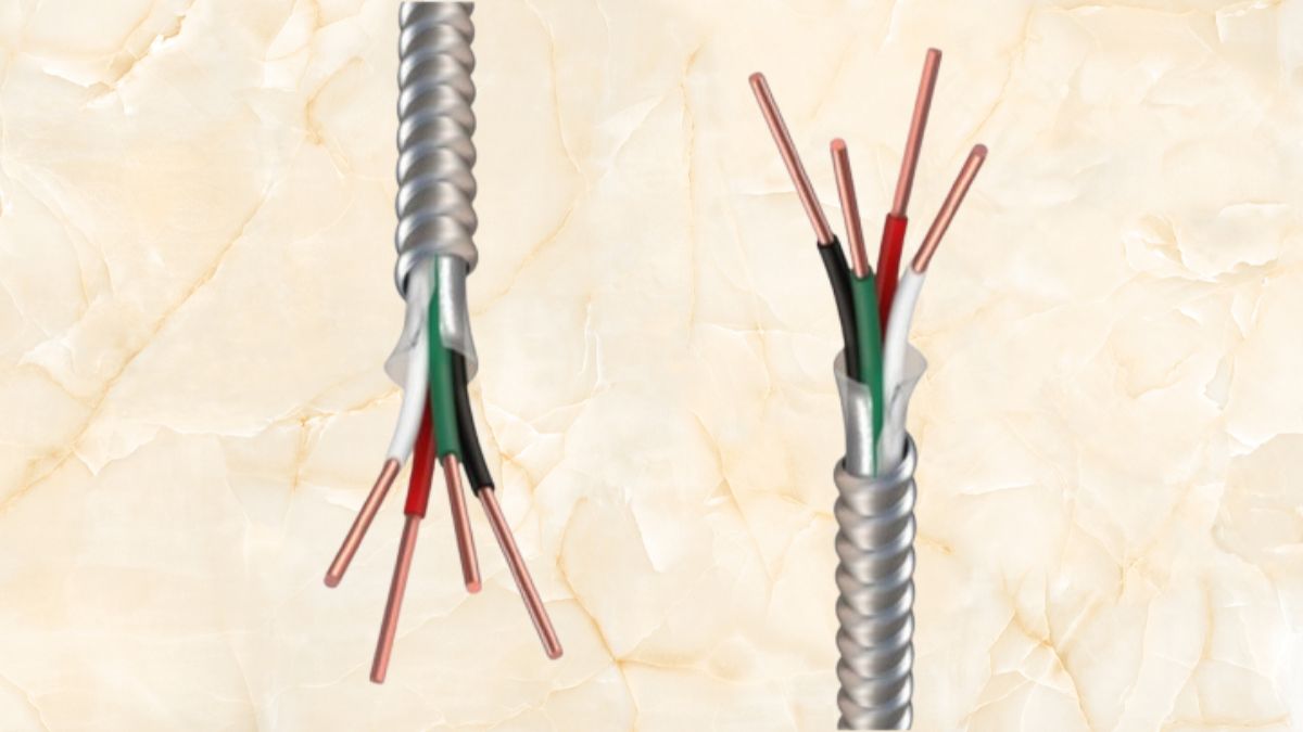 A close-up image of a metal clad cable with exposed copper conductors, color-coded insulation, and a protective aluminum armor for electrical wiring.