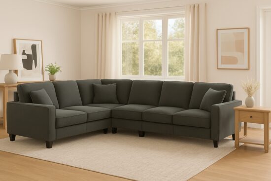 Dark green Bush Furniture 87-inch L-shaped sectional sofa with accent pillows in a bright living room with light wood furniture and soft curtains.