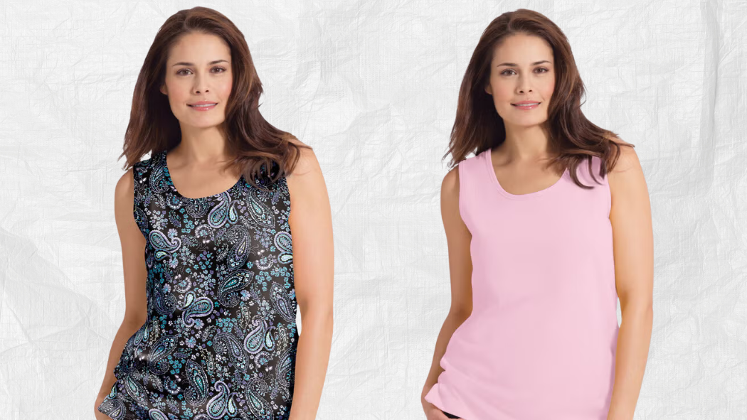 Woman modeling sleeveless tops, one in a black paisley print and one in solid light pink.