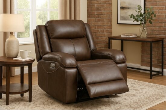 Brown genuine leather power recliner chair with footrest extended, placed in a cozy living room next to a side table and window.
