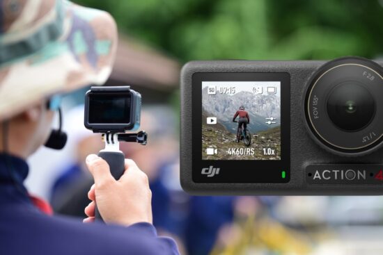 Person filming with an action camera while a DJI Osmo Action 4 displays a mountain biking scene on its screen.