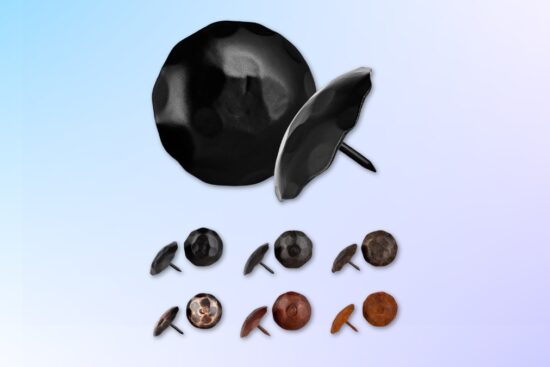 A set of Borderland Rustic decorative clavos nails in different finishes and sizes, including black, bronze, and rust tones, used for barn doors, wood beams, and gates.