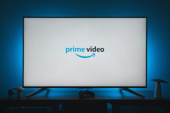 TV screen displaying the Amazon Prime Video logo with a gaming controller on the table.