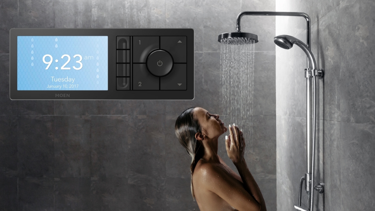 Woman enjoying a shower with water running from a smart shower system and a Moen Smart Shower Controller Matte Black on the wall.