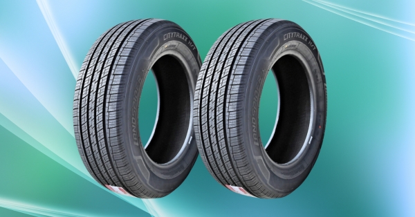 Two Landspider CityTraxx H/T tires shown side by side with black sidewalls and highway tread design.