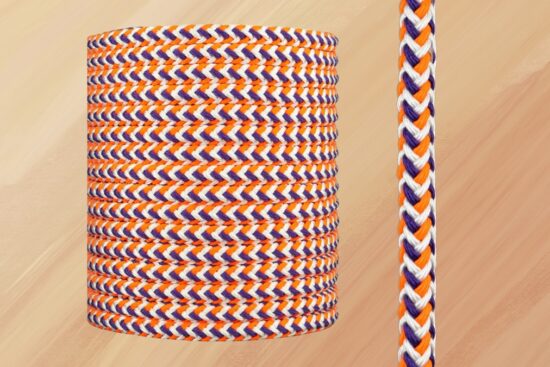 Close-up of a braided arborist rigging rope with orange, purple, and white strands.