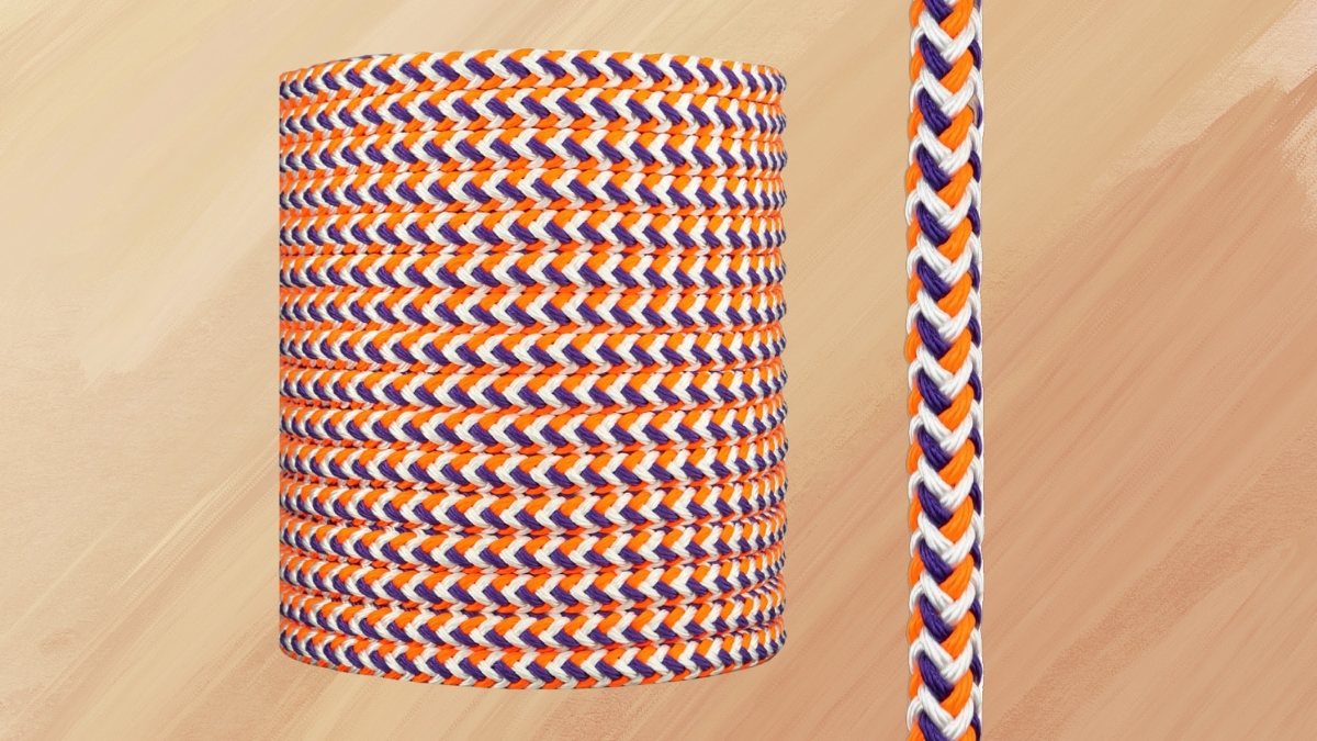 Close-up of a braided arborist rigging rope with orange, purple, and white strands.