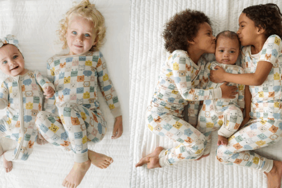 A group of children in matching pastel animal-print pajamas lying on a white quilt, smiling and cuddling.