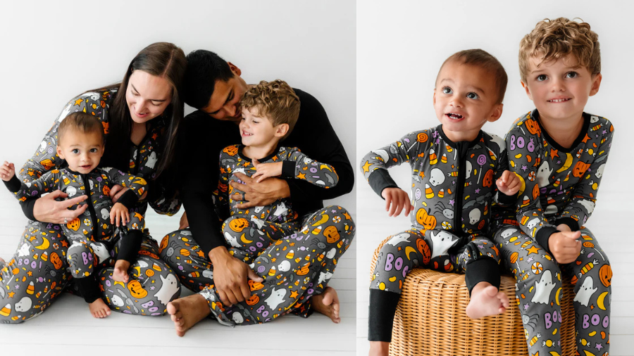 A family of four dressed in matching Halloween-themed pajamas with pumpkins, ghosts, and candy designs.