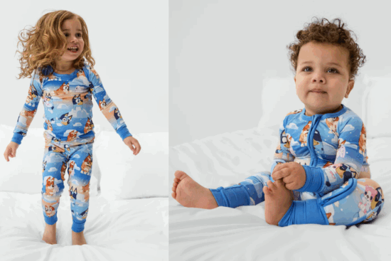 Two young children wearing matching pajamas featuring characters from the cartoon Bluey.