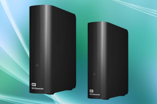 Two black Western Digital external hard drives standing upright against a soft green and blue background.