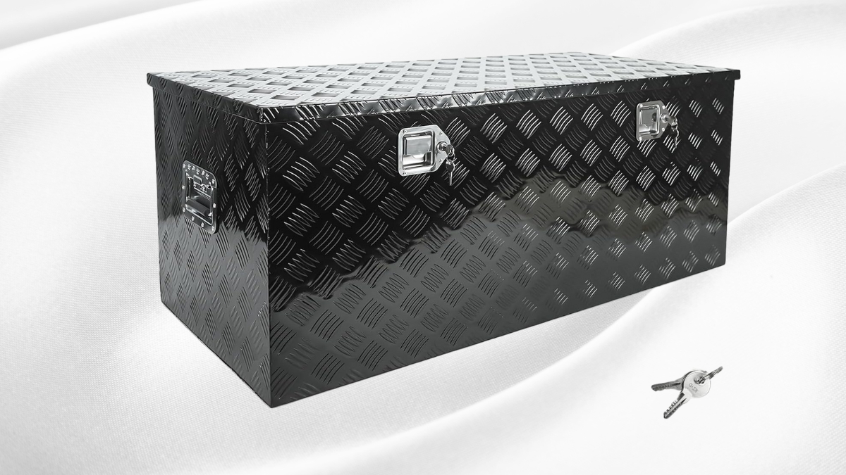 Black aluminum truck toolbox with diamond tread design, shown with two locking latches and a pair of keys on a white background.